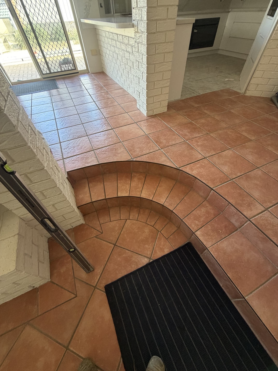Original terracotta tiles and curved steps before the Ocean Reef flooring transformation