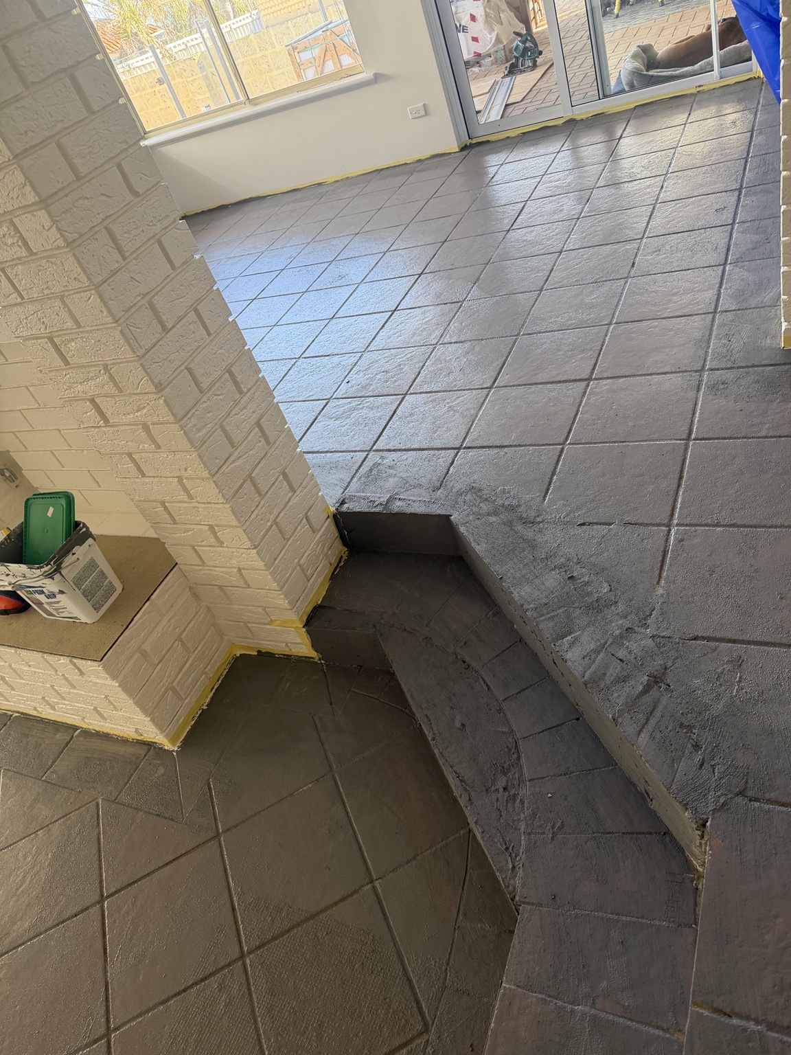 Floor surface preparation in progress around the living-area steps